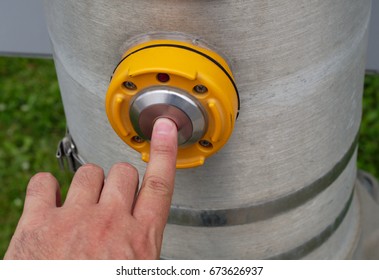 pedestrian pressing button at intersection walker signal yellow street switch