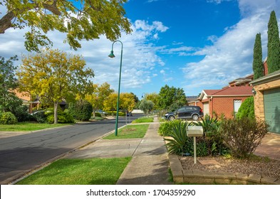 Pedestrian sidewalk/footpath in an Australian suburban neighbourhood. Typical street view in residential suburb. Melbourne, VIC Australia.