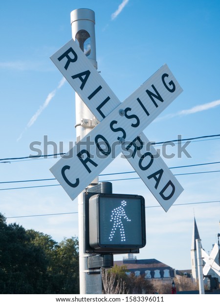Pedestrian\
transit train crossing with warning\
lights.