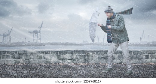 Pedestrian With An Umbrella Is Facing Strong Wind And Rain