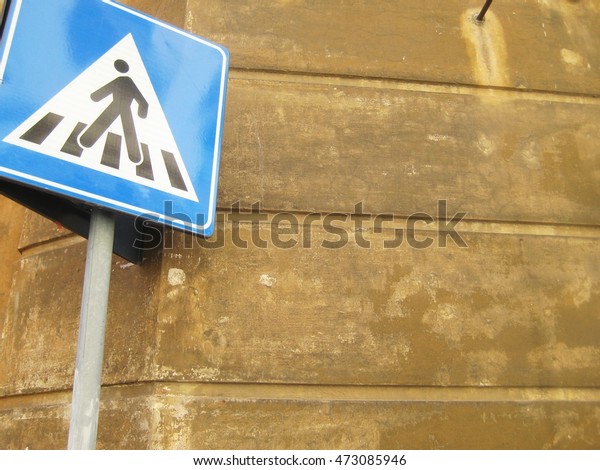 Pedestrian walk sign with empty copyspace\
brown wall\
background