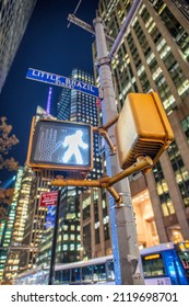 Pedestrian Walk Sign On A Midtown Manhattan Traffic Light At Night