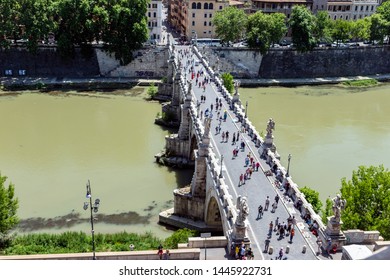 Pedestrian walking on the Sant'Angelo bridge in Rome, Italy. Top view from Castel Sant'Angelo.