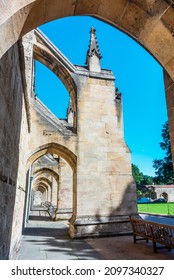 A pedestrian walkway passes through the buttresses supporting either side of the Cathedral on a suuny,summer day with blue skies and shadows. - Shutterstock ID 2097340327