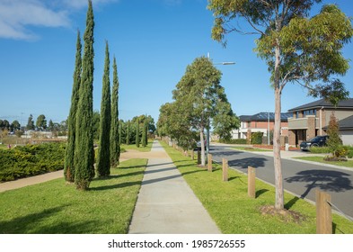 Pedestrian walkway or sidewalk in a suburban street lined with modern residential houses. Beautiful and clean neighborhood view in an Australian suburb. Melbourne, VIC Australia. - Powered by Shutterstock