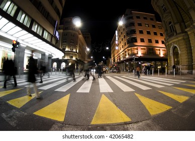 Pedestrian Zebra Crossing On Busy Street At Night