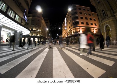 Pedestrian Zebra Crossing On Busy Street At Night