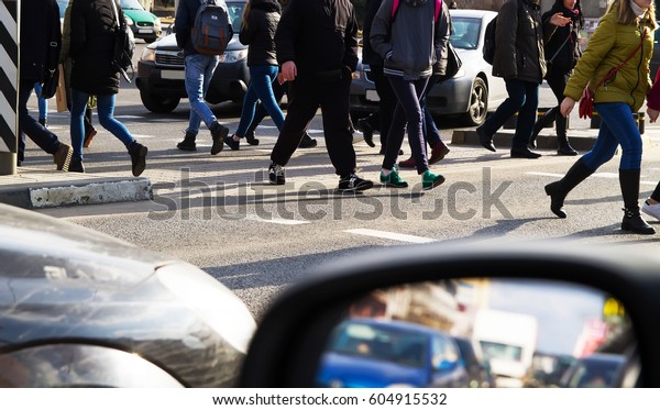 Pedestrians\
cross the street on a pedestrian\
crossing