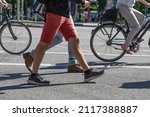 Pedestrians and cyclists cross a street