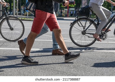 Pedestrians and cyclists cross a street