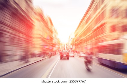 Pedestrians walking and talking and bikers riding bikes - rush hour and busy traffic in Italian city Palermo. Radial zoom effect defocusing filter applied, with vintage instagram look. - Shutterstock ID 255899767