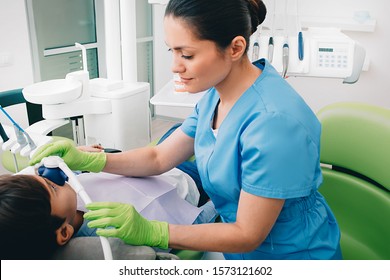Pediatric dentist doing Inhalation Sedation to a child while teeth treatment at dental clinic. Sedation Dentistry