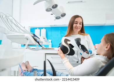 Pediatric Dentist Preparing Kid For Teeth Check-up Using Modern Technology