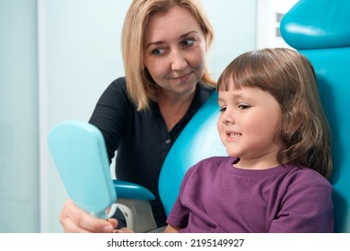 Pediatric Dentist Receiving Little Girl In Her Office