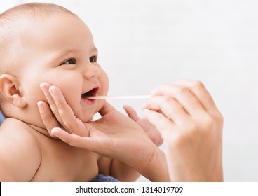 Pediatric Dentistry. Dentist examining little baby's mouth. Oral health and hygiene from born, empty space