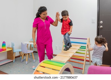 Pediatric Doctor Giving Therapy To A Child In The Playground Of Her Medical Office