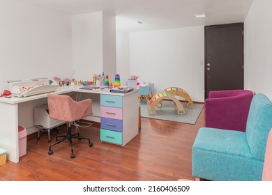 Pediatric Office With Colored Chairs For Waiting Patients, And Pediatric Equipment