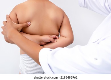 Pediatric Orthopedic Physiotherapist Examining Child's Back In Clinic. Scoliosis Treatment. Vertebrologist Identifies Spinal Problems In Girl. Medicine And Healthcare Concept.