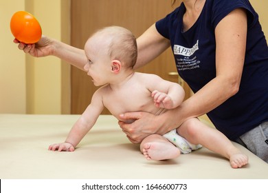 Pediatric Physical Therapy - an infant exercising on a table - Powered by Shutterstock