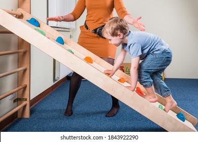 Pediatric Sensory Integration Therapy - a boy on climbing wall - Powered by Shutterstock