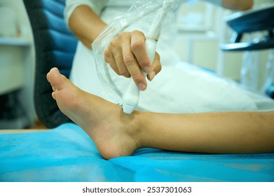 Pediatric ultrasound scan. Child ultrasound. Pediatrician scanning feet. Close up of doctor making foot sonogram for kid. Ultrasound examination of skeletal system. Diseases of joints concept - Powered by Shutterstock