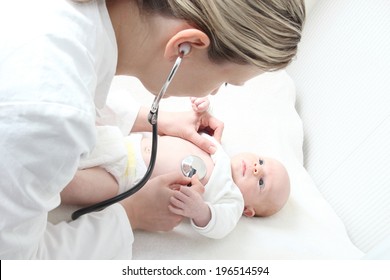 A Pediatrician With  Baby Checking Possible Heart Defect