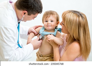 Pediatrician Doctor Examining Kid Boy. Mother Holding Baby.