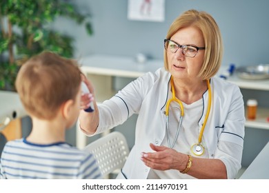 Pediatrician Doctor Examining Little Kids In Clinic Temperature Check