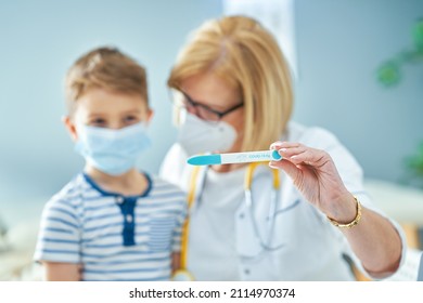 Pediatrician doctor examining little kids in clinic covid test - Powered by Shutterstock