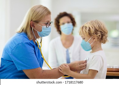 Pediatrician doctor examining sick child in face mask. Ill boy in health clinic for test and screening. Kids home treatment of virus. Coronavirus pandemic. Covid-19 outbreak. Patient coughing.