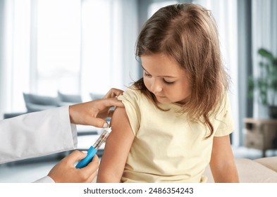 Pediatrician doctor injecting vaccine to child - Powered by Shutterstock