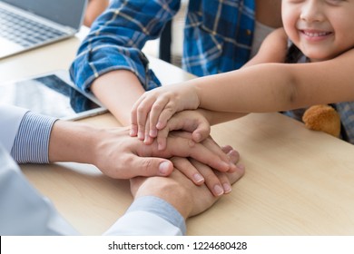 Pediatrician (doctor) Man Join Hands Together,reassuring And Discussing Kid At Surgery.Mother Caucasian And Kid Smiling In Hospital Room.Copy Space.