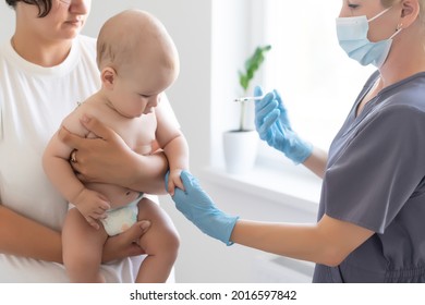 Pediatrician Doctor With Syringe, Tense Mother And Baby