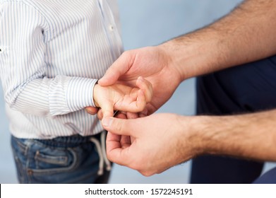 a pediatrician examines the child's hands, a dermatologist treats the hands and looks at the skin, massage the hands and fingers.Concept of examination and treatment of children and skin
 - Powered by Shutterstock