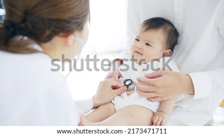 Pediatrician examining a baby. Pediatrics clinic.
