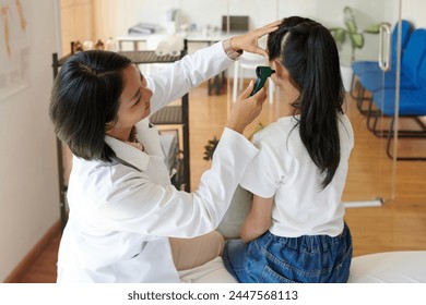 Pediatrician examining ears of sick teenage girl with otoscope - Powered by Shutterstock