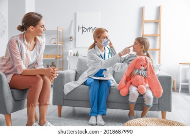 Pediatrician Examining Little Girl At Home