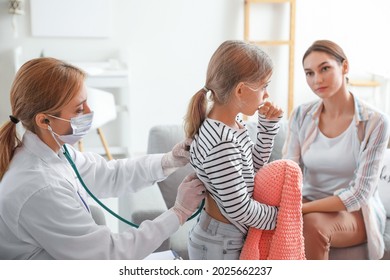 Pediatrician Examining Little Girl At Home