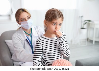 Pediatrician Examining Little Girl At Home