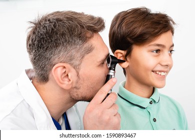 Pediatrician Examining Little Mixed Race Child With Otoscope, Hearing Exam Of Child