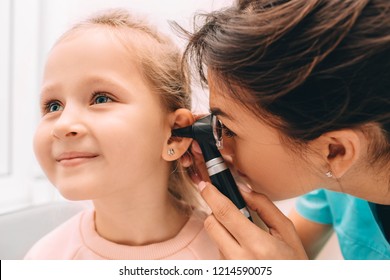 Pediatrician Examining Little Patient With Otoscope, Hearing Exam Of Child