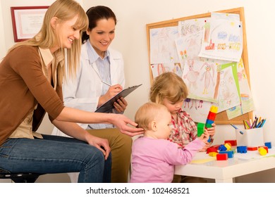 Pediatrician Female Observe Children Playing Activity Fill Medical Report