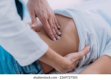 Pediatrician gastroenterologist, medical doctor who specializes in the diagnosis and treatment of gastrointestinal tract disorders doing abdominal examination to a preschooler boy - Powered by Shutterstock