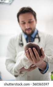 Pediatrician Holding A Beautiful Newborn Baby Boy