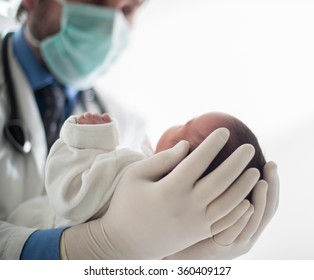 Pediatrician Holding A Beautiful Newborn Baby Boy