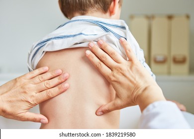 Pediatrician Or Osteopath Treats The Back Of Children During Consultation Hours