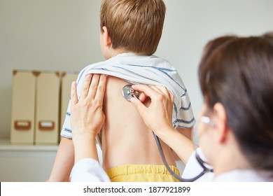 Pediatrician With Stethoscope Listening To A Lungs In Child With Bronchitis And Cough