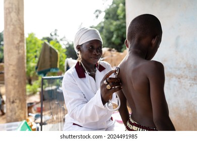 Pediatrician Is Visiting An African Village Family To Check The General Health Status Of An Ill Black Schoolboy With A Suspected Infectious Disease