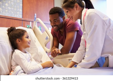 Pediatrician Visiting Father And Child In Hospital Bed