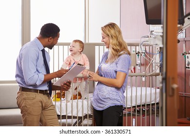 Pediatrician Visiting Mother And Child In Hospital Bed